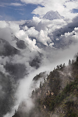 Image showing Nilgiri mountain peak and cloudy Himalayas