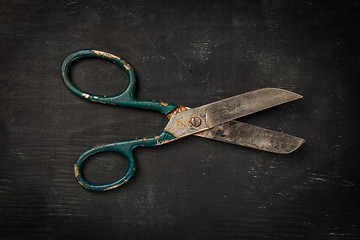 Image showing Vintage scissors on black wooden background