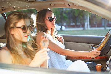 Image showing young women in the car smiling