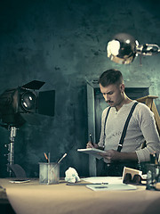 Image showing Architect working on drawing table in office