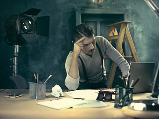 Image showing Architect working on drawing table in office