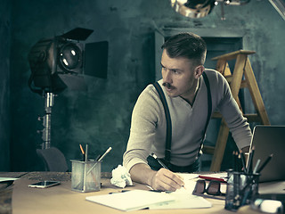 Image showing Architect working on drawing table in office