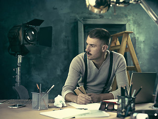 Image showing Architect working on drawing table in office