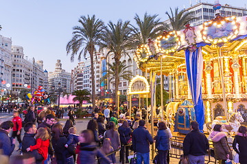 Image showing Christmas fair with carousel on Modernisme Plaza of the City Hall of Valencia, Spain.