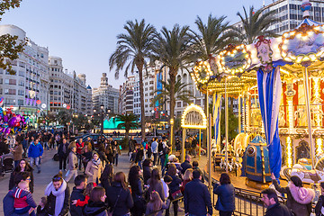 Image showing Christmas fair with carousel on Modernisme Plaza of the City Hall of Valencia, Spain.