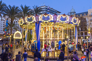 Image showing Christmas fair with carousel on Modernisme Plaza of the City Hall of Valencia, Spain.