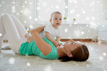 Image showing happy mother playing with baby at home