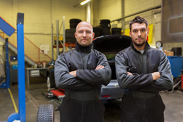 Image showing auto mechanics or tire changers at car shop