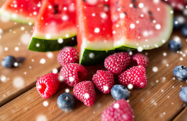 Image showing close up of fruits and berries on wooden table