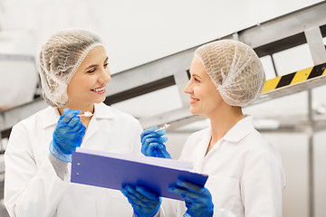 Image showing women technologists tasting ice cream at factory