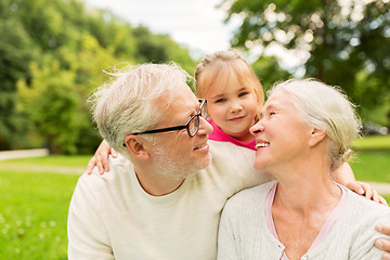 Image showing senior grandparents and granddaughter at park
