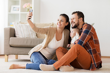 Image showing mother and father with baby taking selfie at home