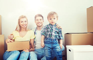 Image showing happy family with boxes moving to new home