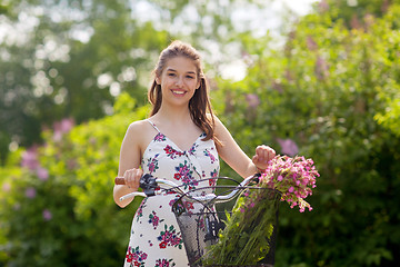 Image showing happy woman riding fixie bicycle in summer park