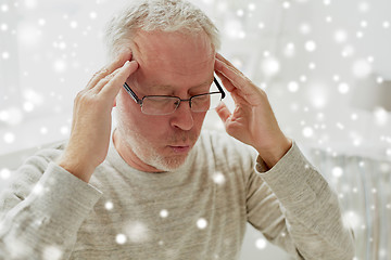 Image showing senior man suffering from headache at home