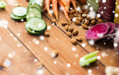 Image showing different vegetables and almond nuts on wood