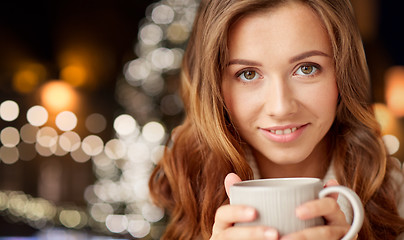 Image showing close up of happy woman with coffee at christmas