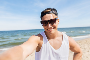 Image showing man in sunglasses taking selfie on summer beach