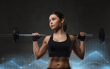 Image showing young woman flexing muscles with barbell in gym