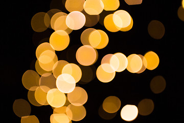Image showing blurred golden lights over dark background
