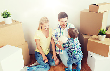 Image showing happy family moving to new home and playing ball