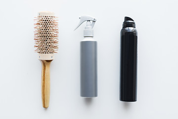 Image showing styling hair sprays and curling brush