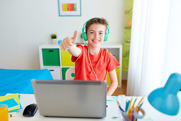 Image showing boy in headphones with laptop showing thumbs up