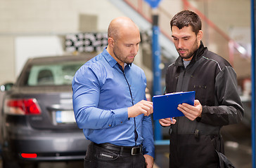 Image showing auto mechanic and customer at car shop
