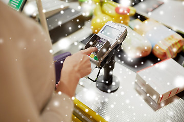 Image showing woman entering pin code at store cash register