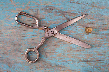 Image showing Retro sewing accessories on blue wooden background