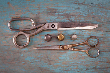 Image showing Retro sewing accessories on blue wooden background