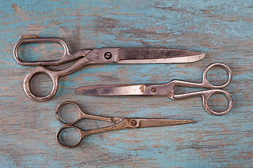 Image showing A set of vintage scissors on blue wooden background