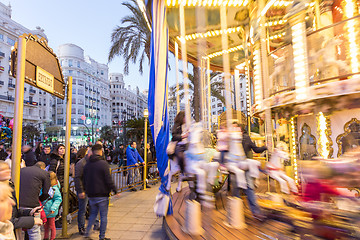 Image showing Christmas fair with carousel on Modernisme Plaza of the City Hall of Valencia, Spain.