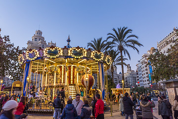 Image showing Christmas fair with carousel on Modernisme Plaza of the City Hall of Valencia, Spain.