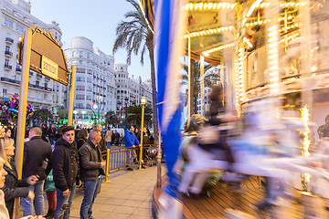 Image showing Christmas fair with carousel on Modernisme Plaza of the City Hall of Valencia, Spain.