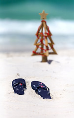 Image showing Australia flag thongs on a white sandy beach at Christmas