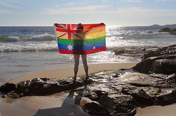 Image showing Female holding an Australian flag in rainbow colours