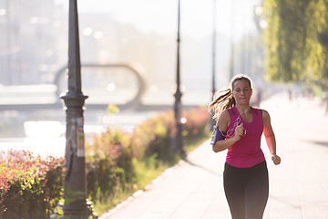 Image showing woman jogging at sunny morning