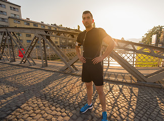 Image showing portrait of a jogging man at sunny morning