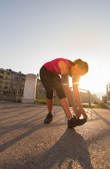 Image showing athlete woman warming up and stretching