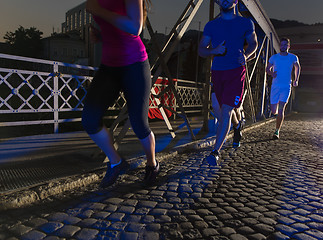 Image showing young people jogging across the bridge