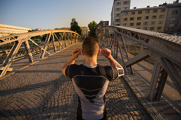 Image showing portrait of a jogging man at sunny morning