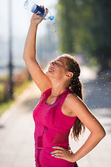 Image showing woman pouring water from bottle on her head