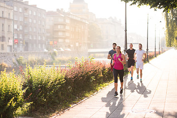 Image showing group of young people jogging in the city