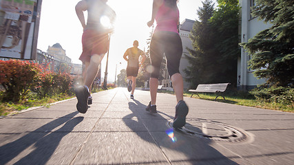 Image showing group of young people jogging in the city