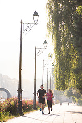 Image showing young couple jogging  in the city