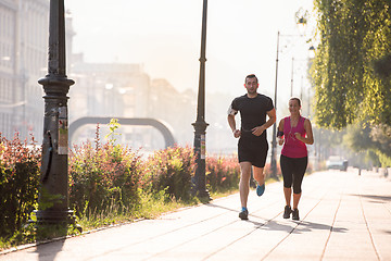 Image showing young couple jogging  in the city