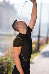 Image showing man pouring water from bottle on his head