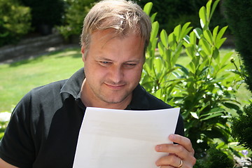 Image showing Man reading a letter