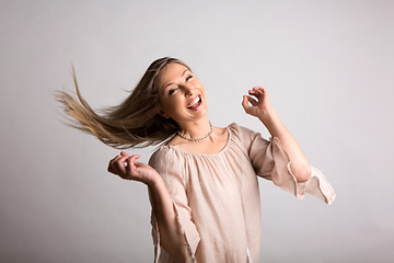 Image showing Smiling carefree natural  spirited woman flicking long hair